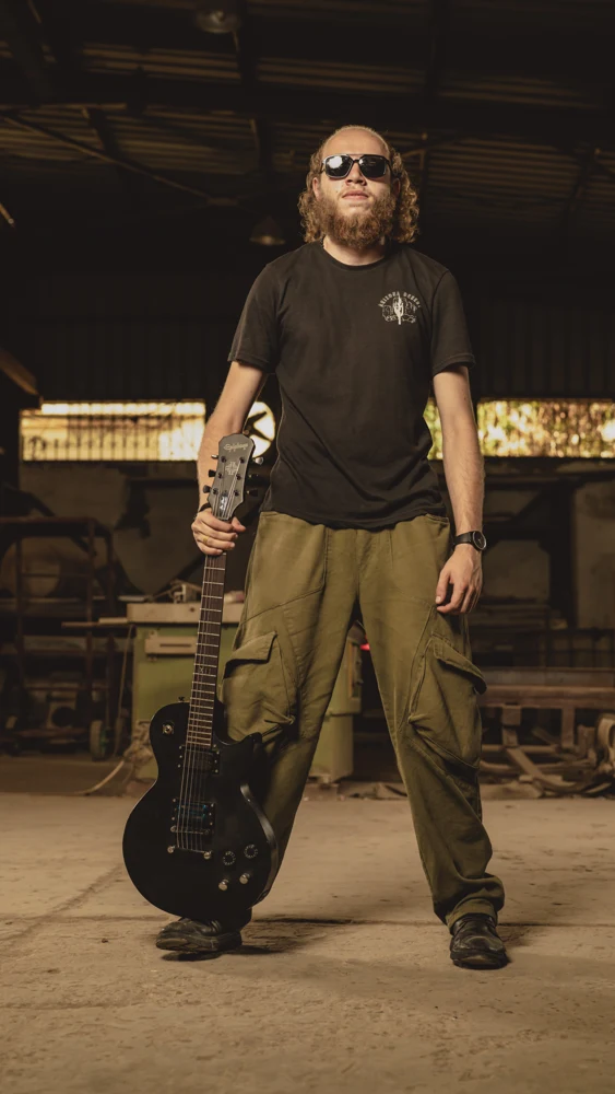 Aly Fansa standing with his guitar
